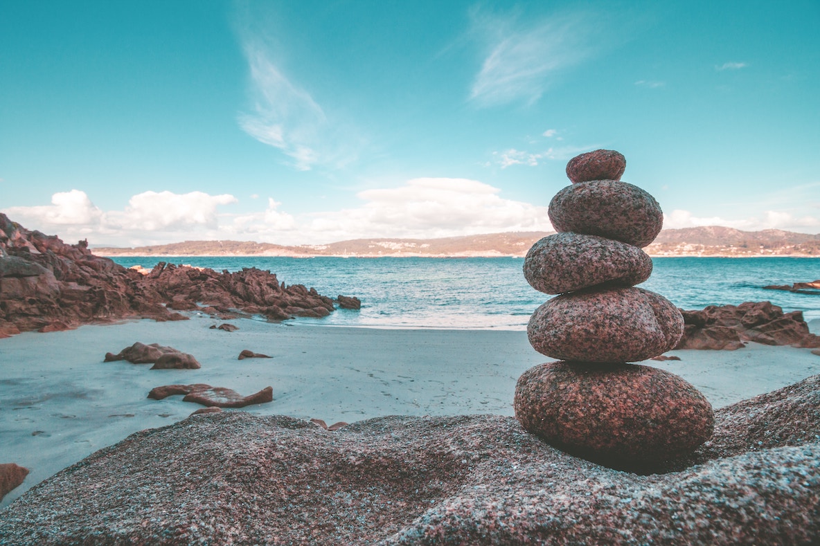 peaceful landscape of stacked rocks, cairns and sea